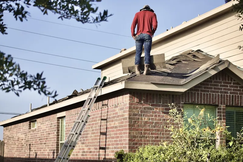 Professional roofer working on a residential roof in Northeast Bellevue